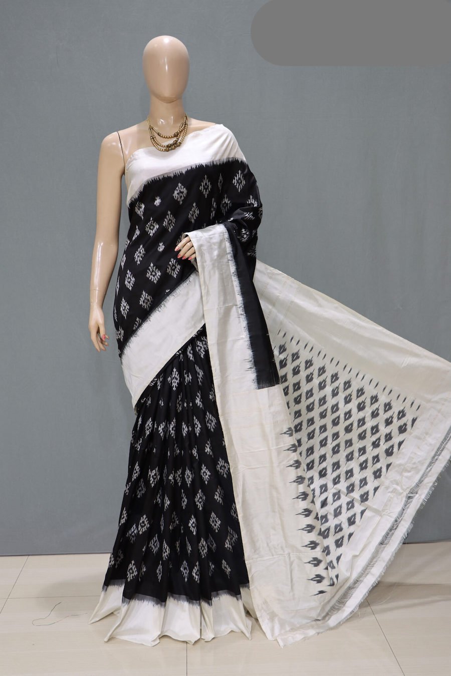 Black saree with white ikkat pattern, white border and pallu in black white pattern